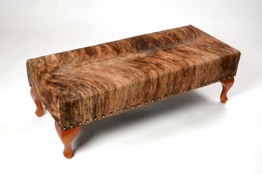 Cowhide ottoman with wood cabriole legs