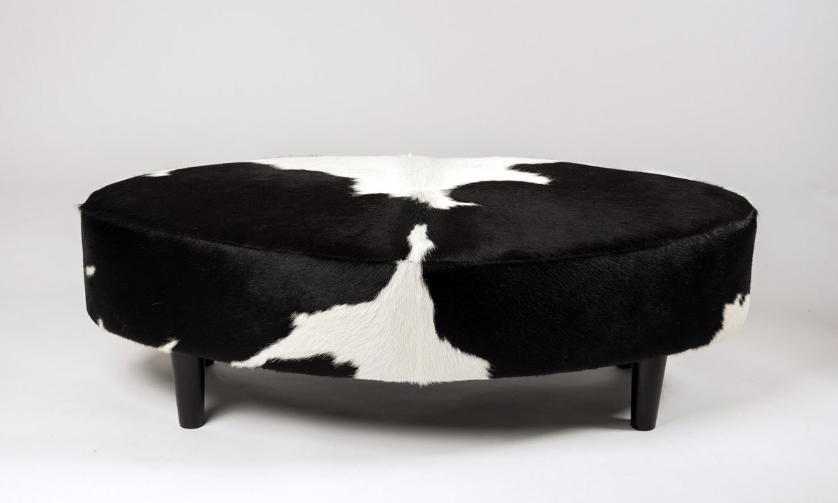 Oval ottoman in black and white cowhide