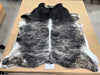 A beautiful dark sand and black exotic stripe cowhide rug