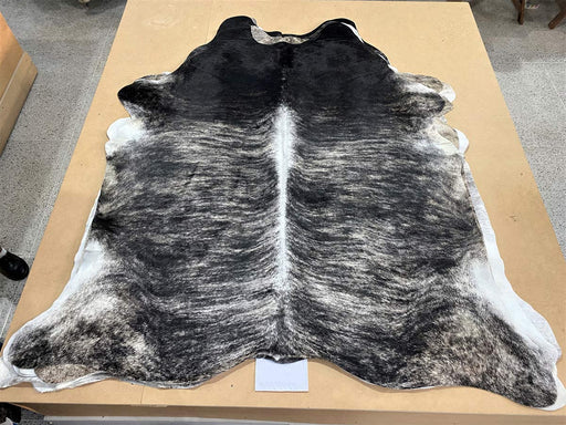 A beautiful dark sand and black exotic stripe cowhide rug