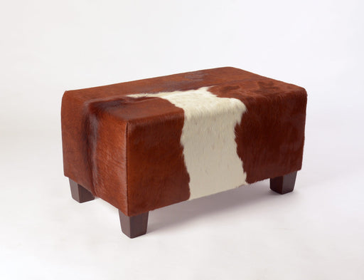 Small cowhide footstool in brown and white hide.