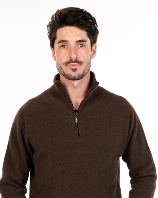 Man wearing a brown half-zip sweater made from possum merino
