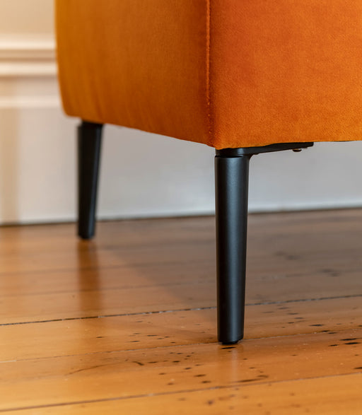 Bright orange velvet ottoman