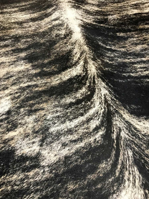 Rare exotic cowhide rug detail in black sand pattern