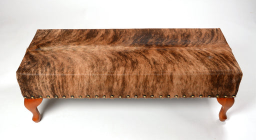 Cowhide ottoman with wood cabriole legs